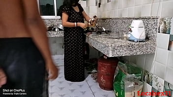 African-American woman engages in sexual activity with her husband in the kitchen